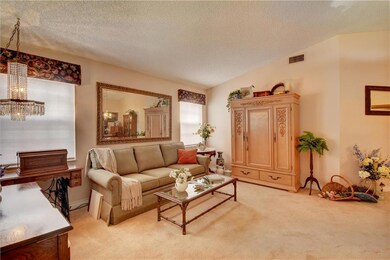Formal living room with vaulted ceiling, light and