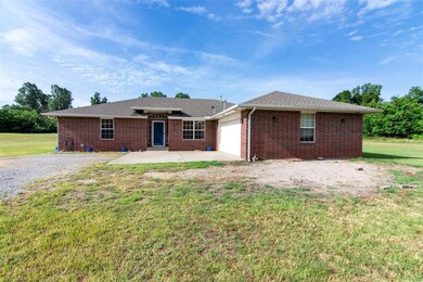 Ranch-style house with a patio and a front lawn