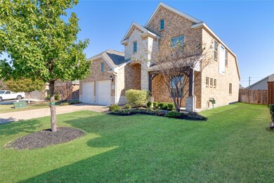 View of property featuring a front yard and a gara