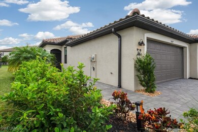 View of side of property with stucco siding, drive