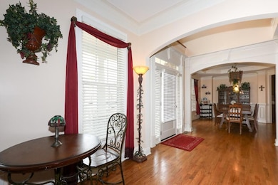 Dining area featuring arched walkways, a chandelie