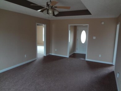 Den has a ceiling fax and tray ceiling.