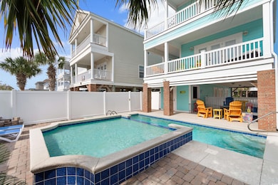 View of swimming pool with a patio and a hot tub