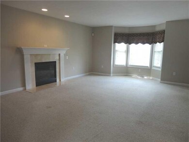 Family Room. This lovely family room offers a lovely gas fireplace w/ wood mantel, recessed lighting, and a bumpout bay with 3 windows offering a great view of the manicured front lawn.
