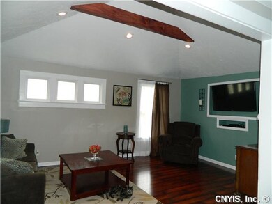 Living Room. Vaulted ceiling in living room with built-in for flat screen tv and gleaming floors.