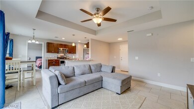 Living area with a raised ceiling, ceiling fan, li