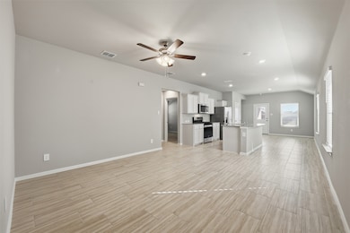 Unfurnished living room featuring ceiling fan, wood finish floors, and recessed lighting