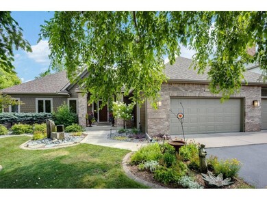 Front of house with beautiful mature trees, water 