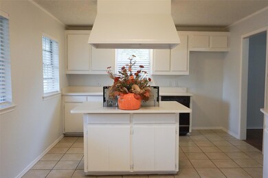 Kitchen featuring custom exhaust hood, a center is