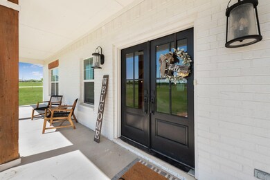 Entrance to property featuring a porch and french doors