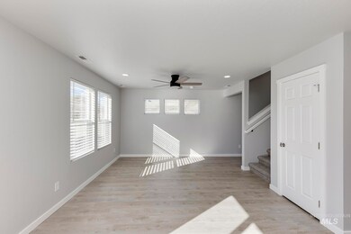 Unfurnished living room featuring light wood-style floors, ceiling fan, stairs, and recessed lighting
