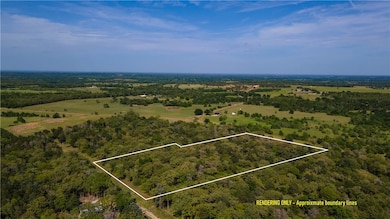 Wooded acreage with small clearings and paved coun