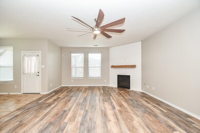 Spacious and inviting living space with a cozy fireplace centerpiece.