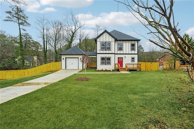 Tudor-style house with concrete driveway, board an