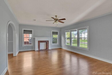 Living room with natural light, hardwood floors, a