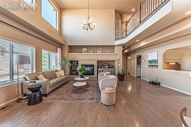 Living room with a notable chandelier, visible ven