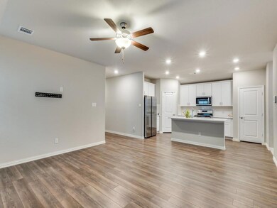 Kitchen featuring white cabinets, appliances with 