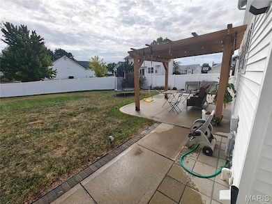 Fenced backyard with a patio, a trampoline, and a pergola
