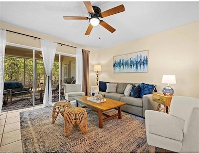 Living room with tile patterned floors and a ceili