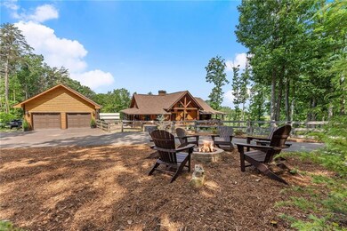 View of yard featuring a detached garage and a fire pit