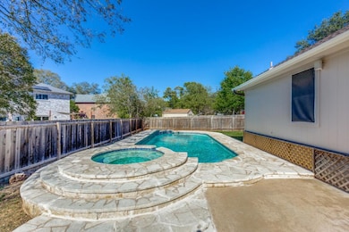 View of pool with a fenced backyard, a patio area, and a pool with connected hot tub