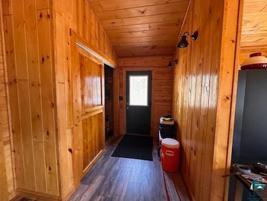 Doorway to outside with dark wood-style flooring, 