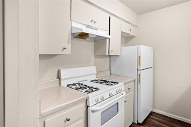 Kitchen featuring white appliances, under cabinet