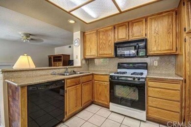 THE KITCHEN FEATURES GRANITE COUNTER TOPS, BREAKFA