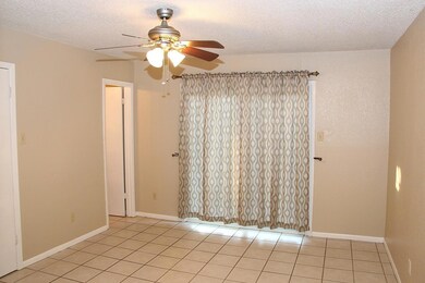 Unfurnished room with a ceiling fan, light tile p