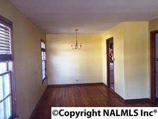 LIVING ROOM/DINING ROOM COMBINATION WITH HARDWOOD FLOORING.