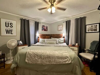 Bedroom with hardwood / wood-style flooring, ornam