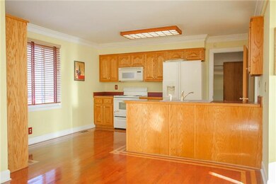 A view of the Kitchen that offers Hardwood Floors, Pantry and a view of the Back Yard from the Kitchen Window.