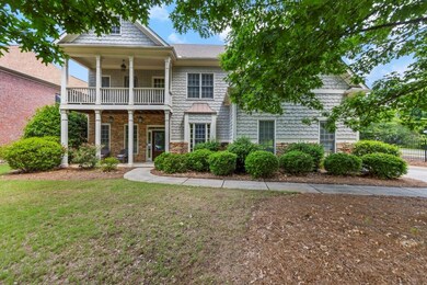 View of front of property featuring a balcony, sto