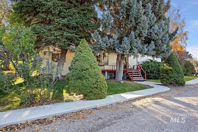 View of front of property featuring a front lawn and a deck