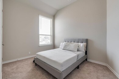 Carpeted bedroom with baseboards and lofted ceili