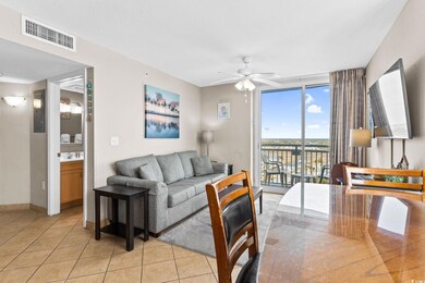 Living room with light tile patterned floors and c