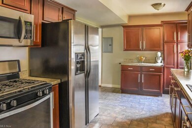 Stainless steel appliances and tile flooring in th