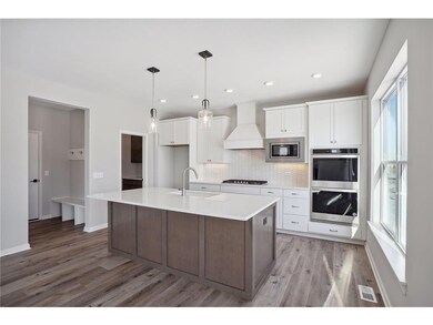The stunning gourmet kitchen features a double wal