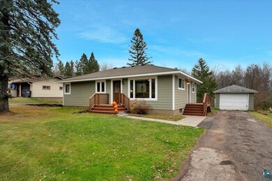 Single story home with a front yard, a garage, and
