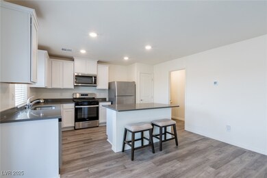 Kitchen featuring stainless steel appliances, a si