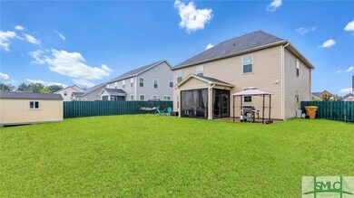 Large fenced backyard with shed, screened patio an