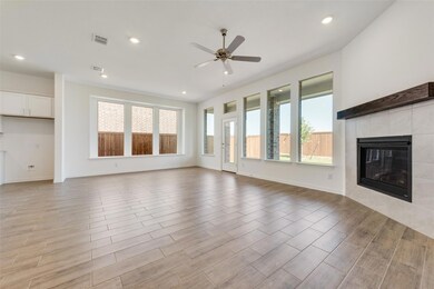 Unfurnished living room featuring ceiling fan, lig