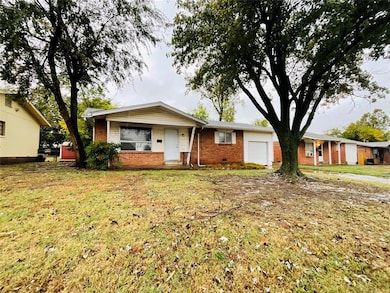 Single story home featuring a garage and a front l