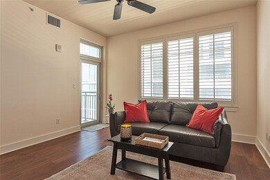 Living area with dark wood finished floors, visib