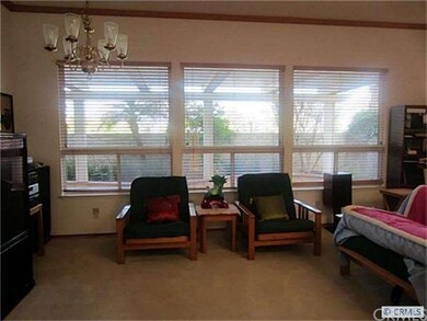 The wall of windows in the formal living room look