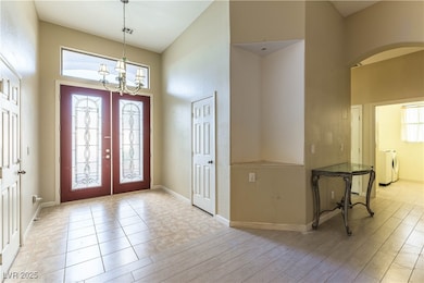 Entrance foyer featuring french doors, a towering