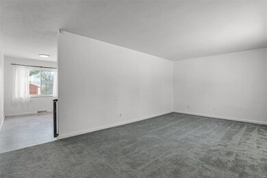 The living room seamlessly flows into the dining area.
