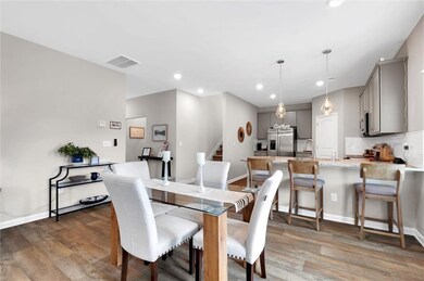 Dining space featuring wood finished floors, reces