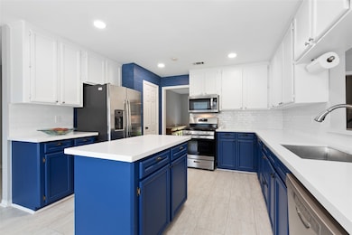 Island kitchen with miles of cabinets and counter