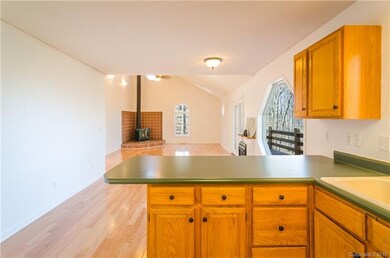 Open floor plan shows off wood stove. Great for en
